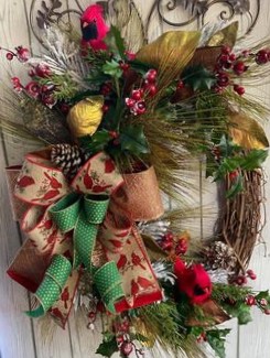 Large Grapevine wreath with Christmas pine greenery, 2 red cardinal birds, gold magnolia leaves, and a large bow with gold,, tan with red cardinals, and green with gold dot ribbons.